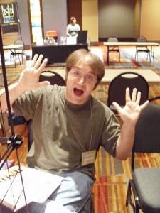 Chris sitting behind my table, very excited.